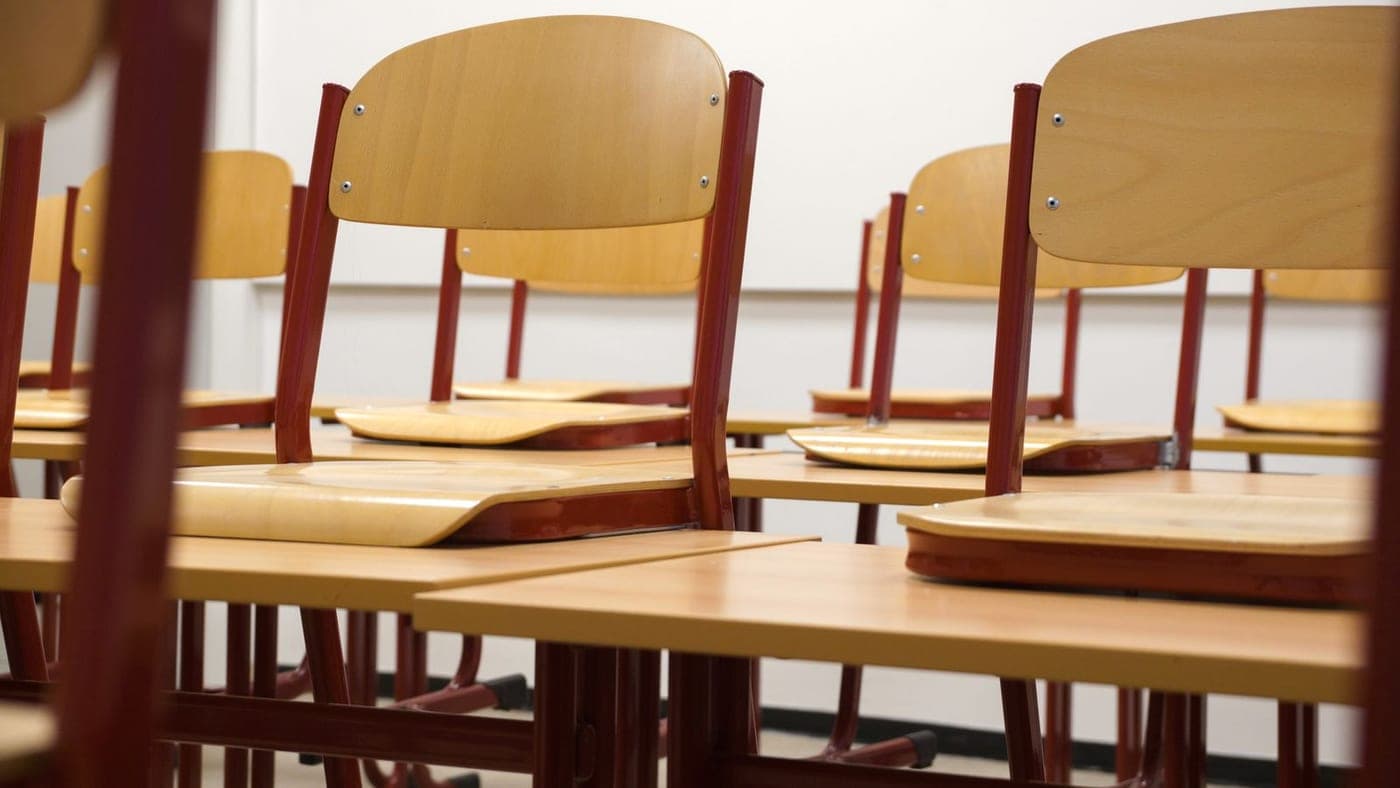 Salle de classe chaises relevées, prête pour l'entretien